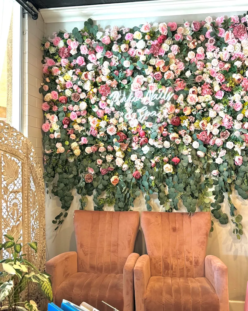 Signature pink flower wall with neon Pinko sign