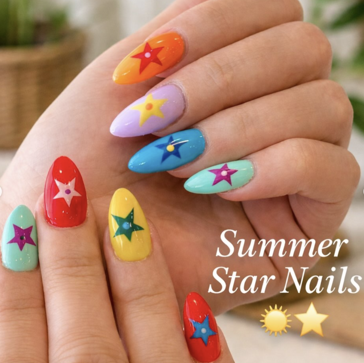 Colorful summer nail set with star motifs across bright glossy shades.